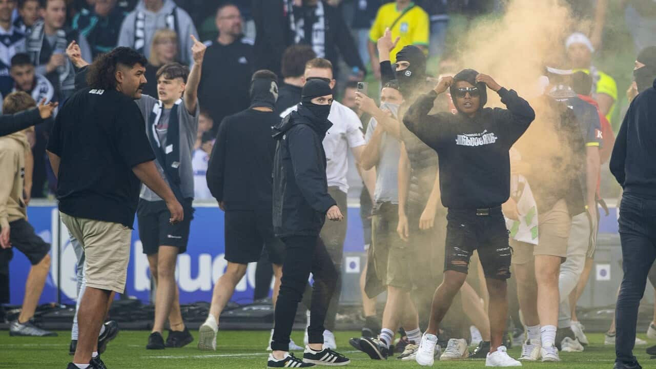 Melbourne Victory fans invade the pitch during the A-League Men's football match on 17 December 2022.