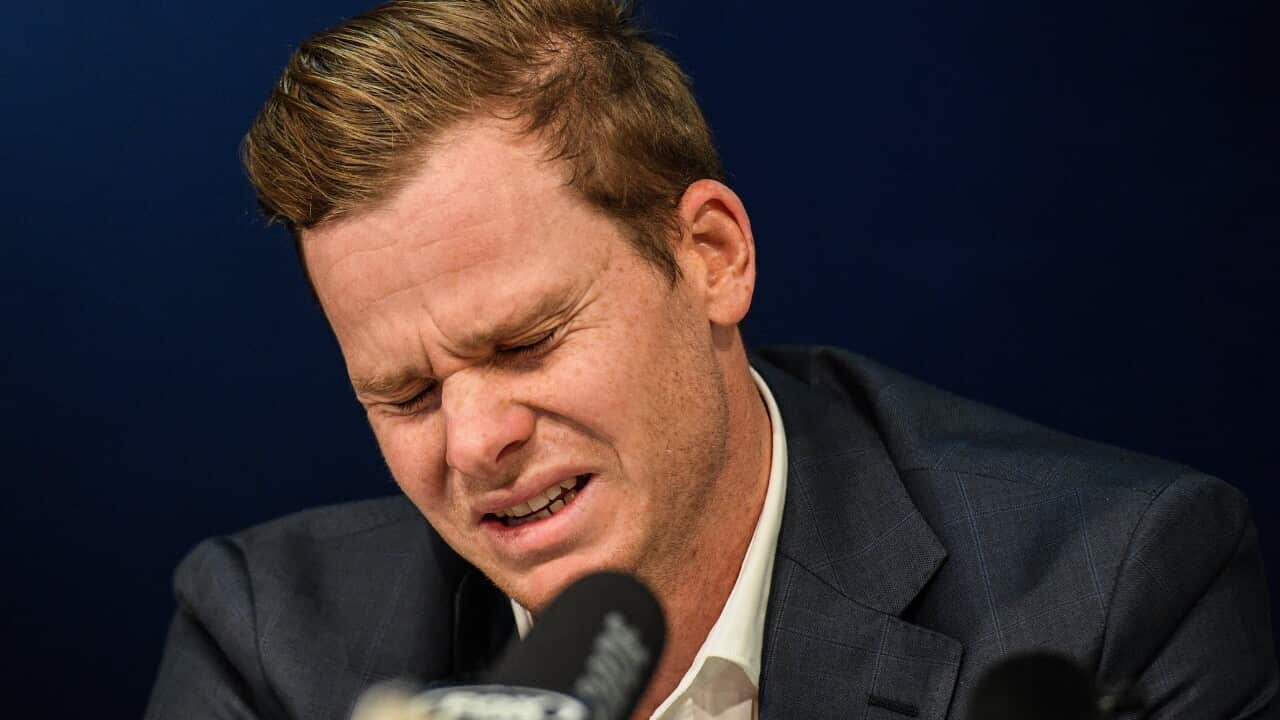 Disgraced Australian Cricket Captain Steve Smith reacts during a press conference after arrives at Sydney International Airport.