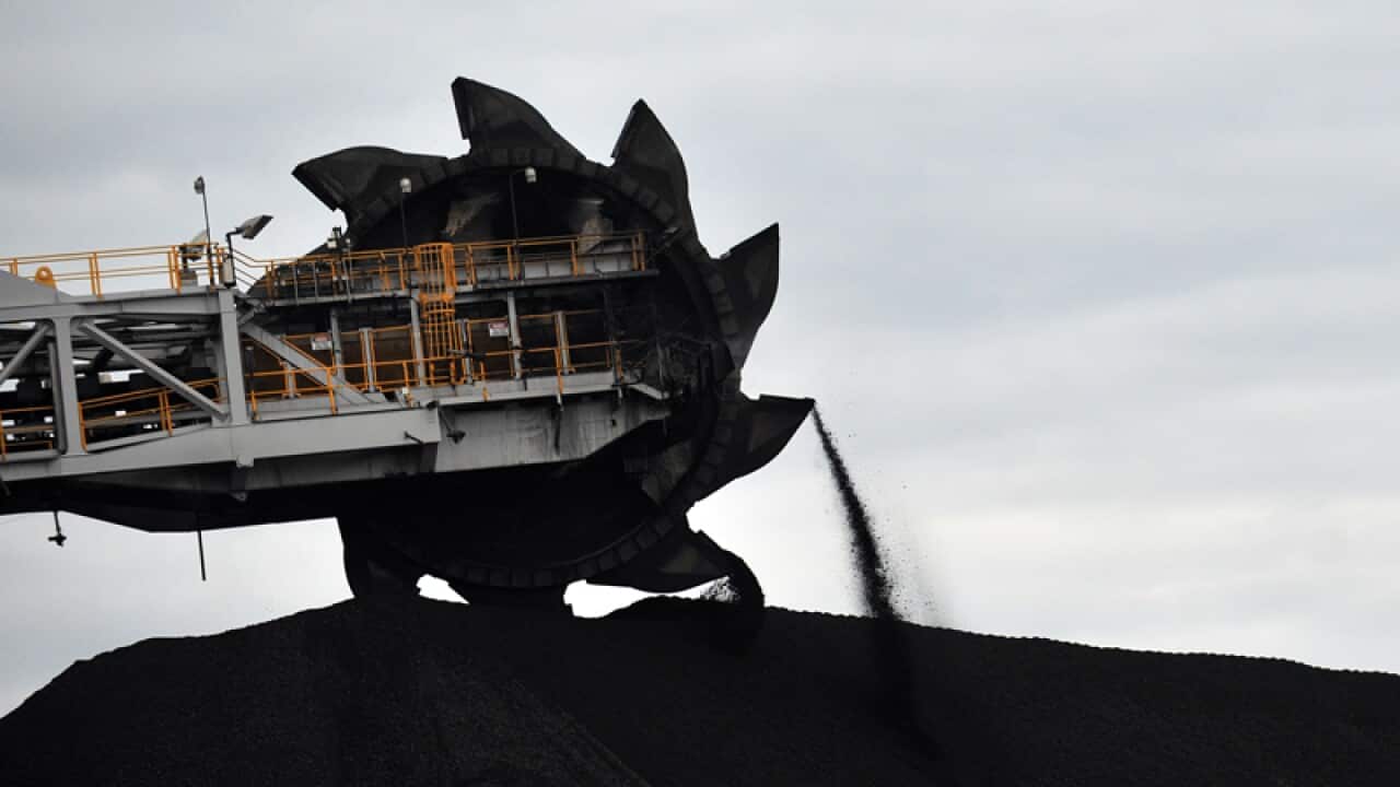 A loader shifts coal