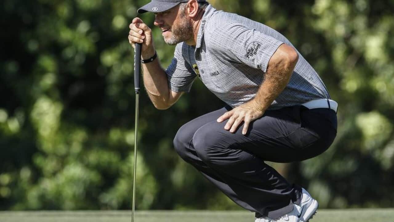 Lee Westwood of England aligns his putt.