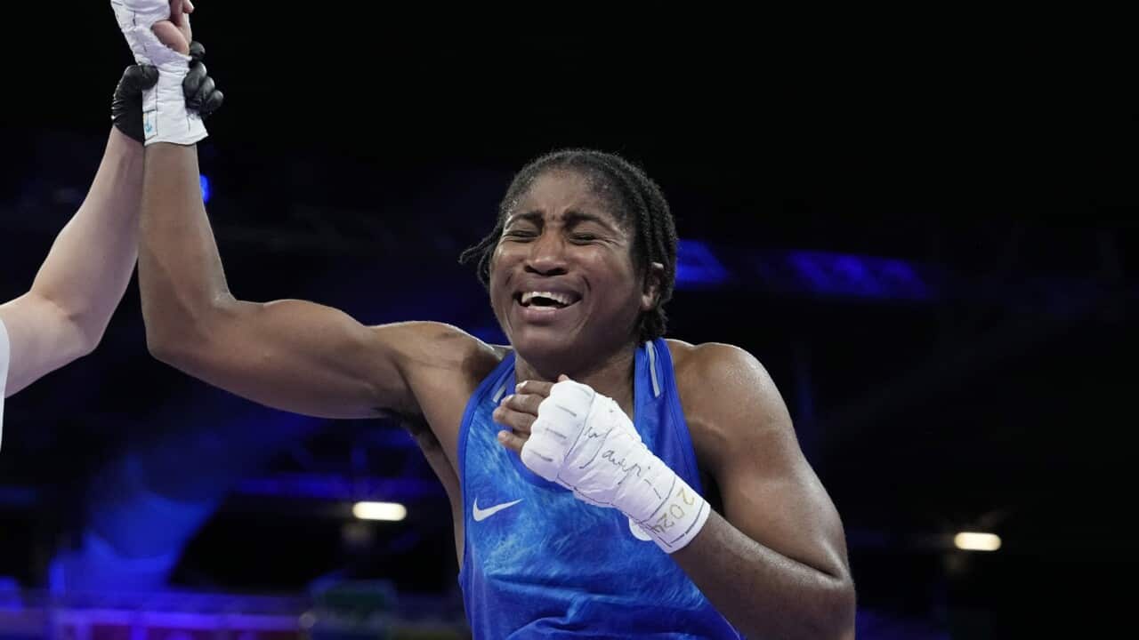 Cindy Ngamba holds up her right arm after the boxing bout ends.