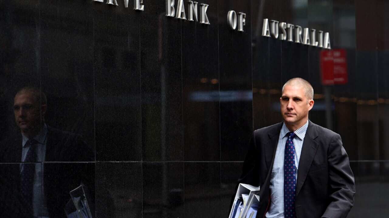 A pedestrian walks past the Reserve Bank of Australia