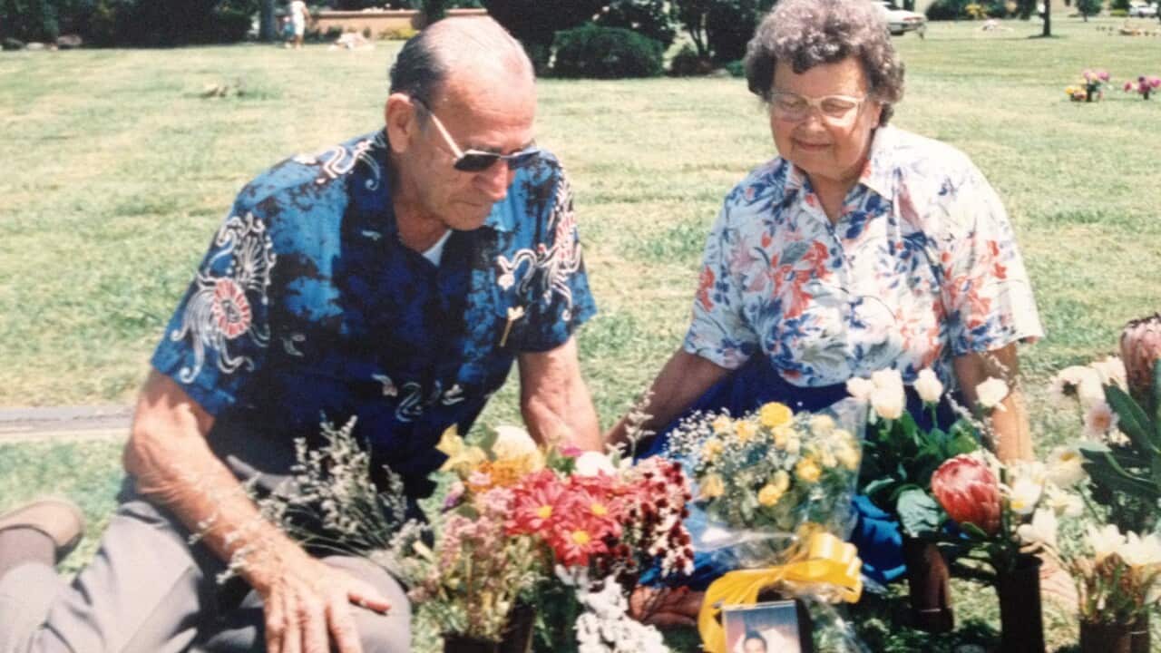 Anita Cobby's parents at her grave site with flowers on display