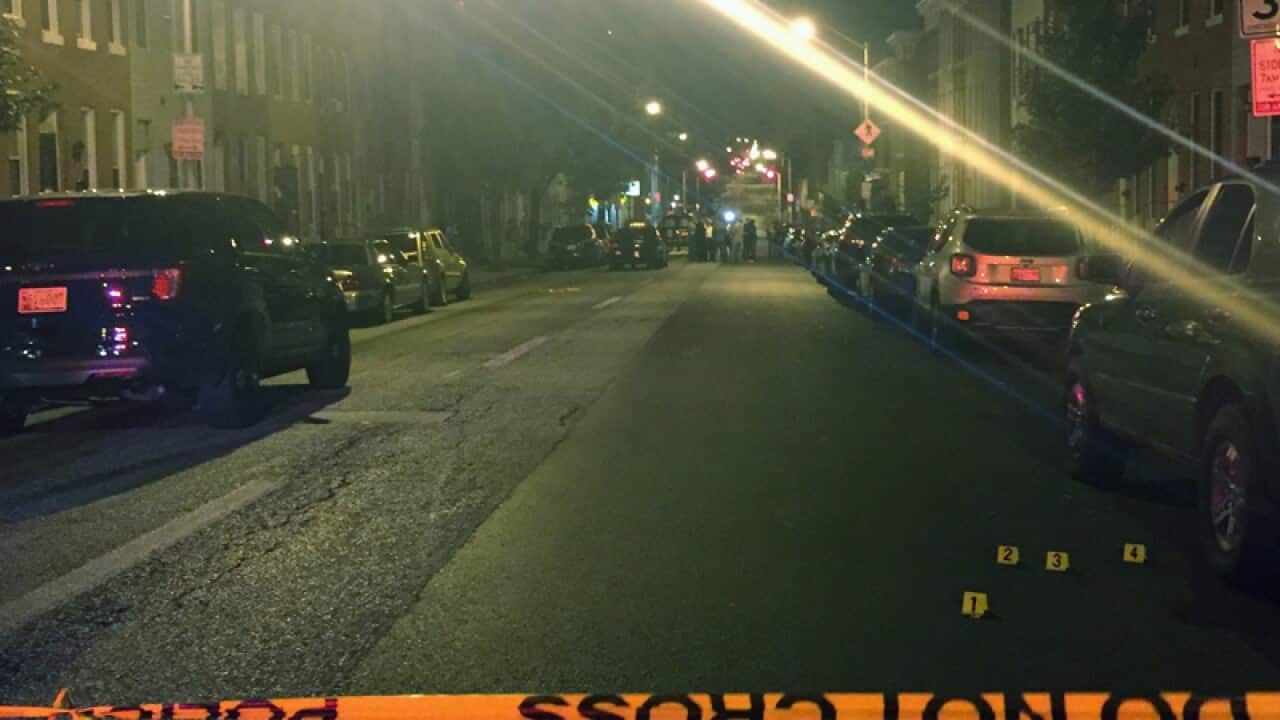 Police investigate the scene of a multiple shooting in Baltimore