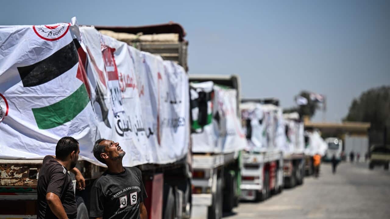 Trucks with humanitarian aid wait at Rafah border