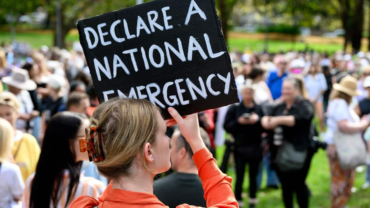 A women holds up placard during a rally to a call for action to end violence against women in Sydney