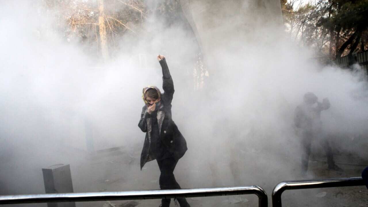 Iranian students clash with riot police during an anti-government protests around the Tehran University in Tehran, Iran