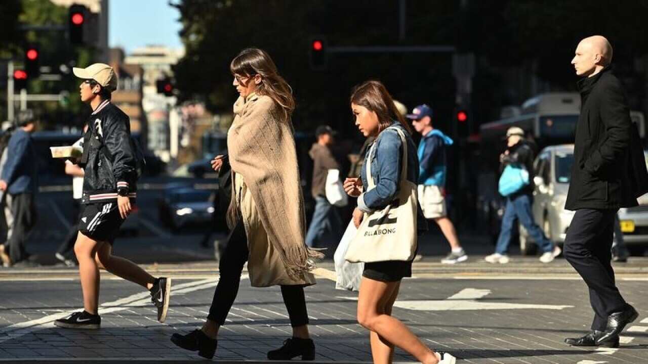People cross a street in the Sydney CBD