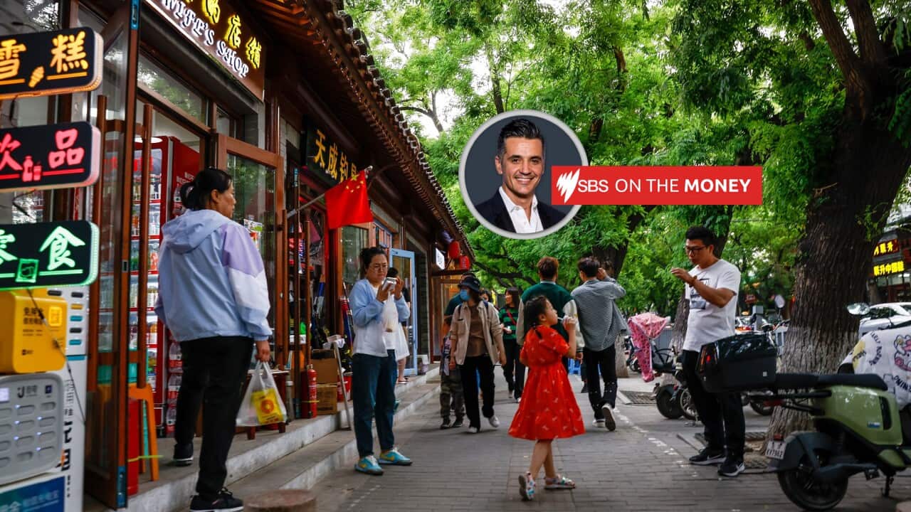 People walk alongside stores in Beijing, China on 10 May 2023.