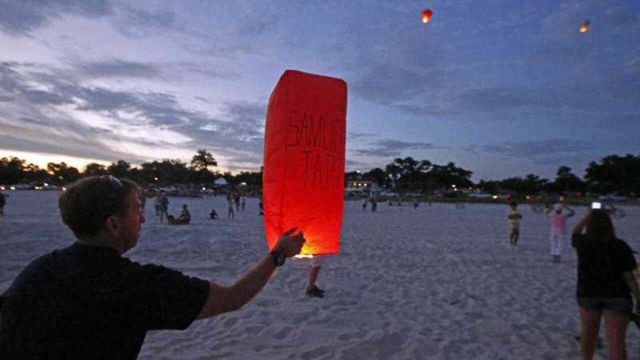 Volunteers light balloons with the names of residents who died during Hurricane Katrina at memorial service. (AP)