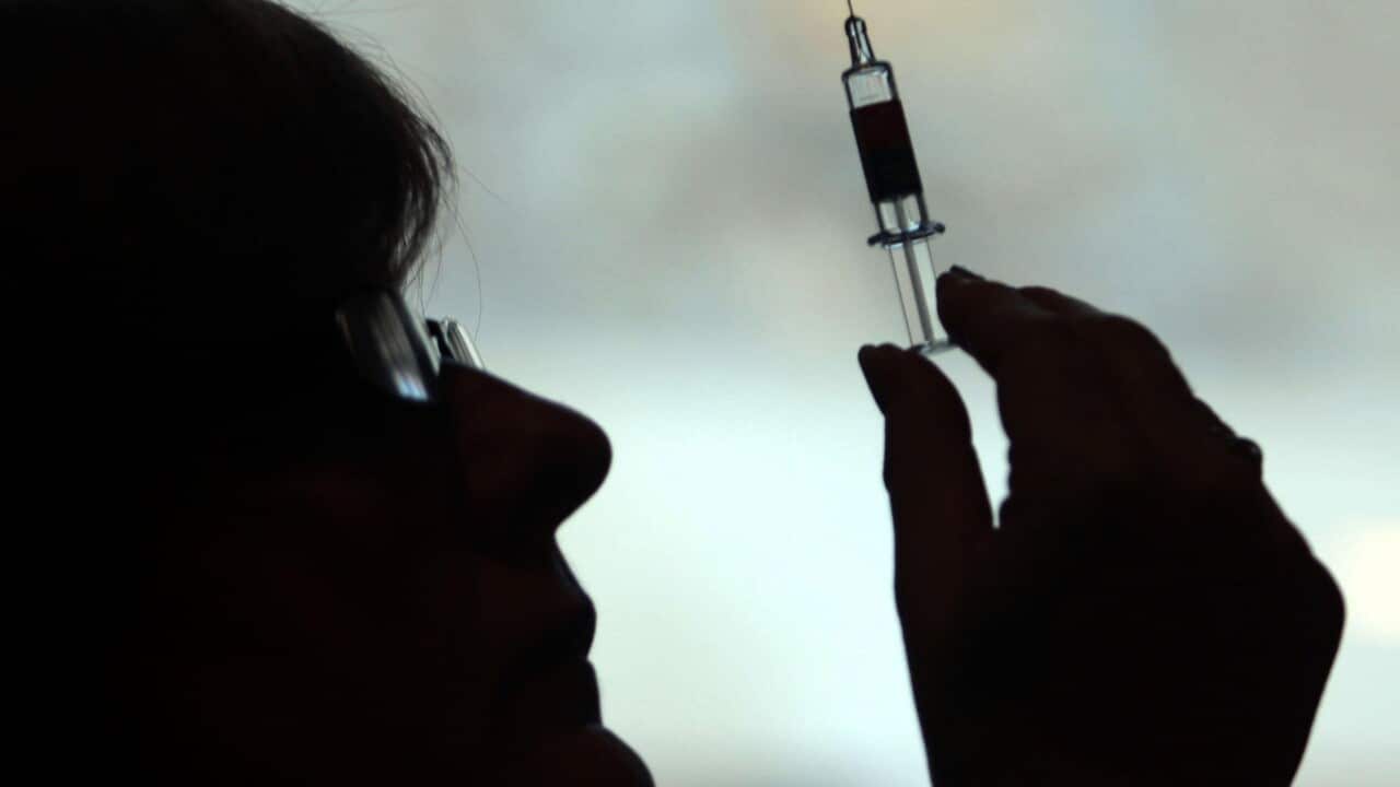 Nurse preparing to give a patient an injection. (AAP)