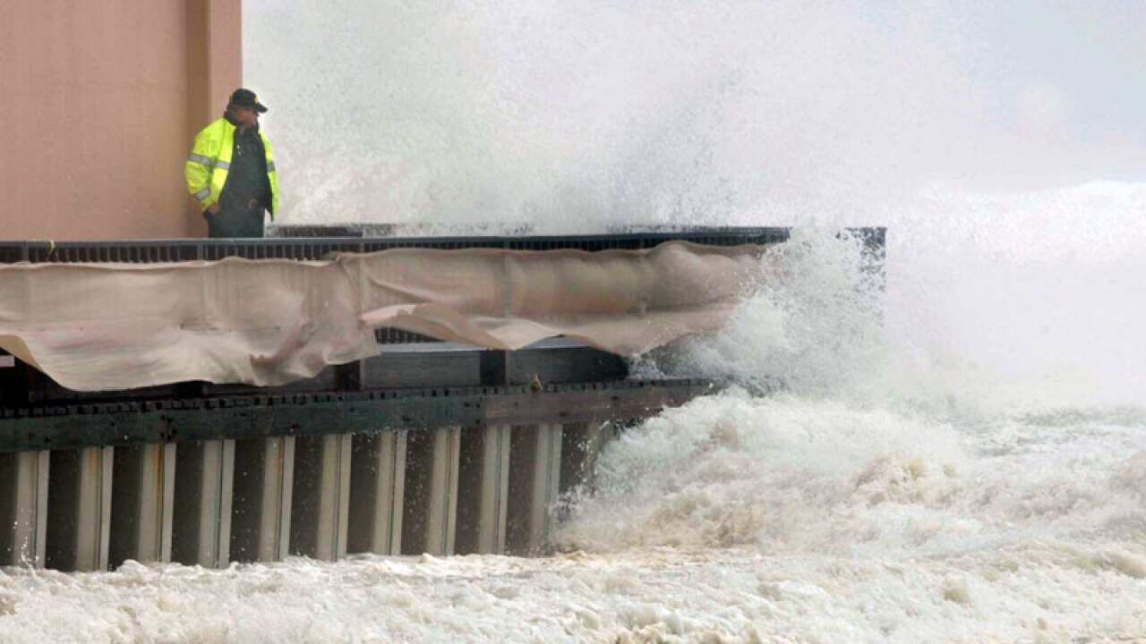 A resident in Okaloosa Island in Fort Walton Beach, Florida, comes to see the effects of Hurricane Isaac as it churns through the Gulf of Mexico. (AAP)