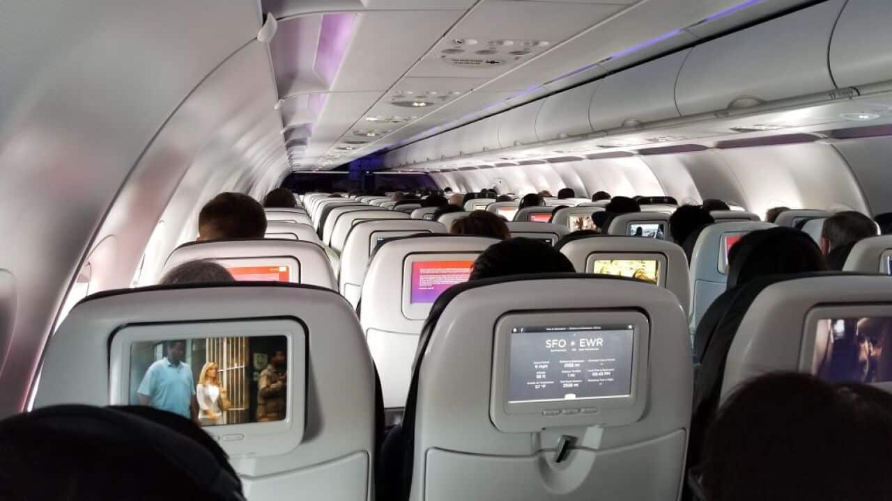 File photo of passengers on a Virgin America flight, March 15, 2018.