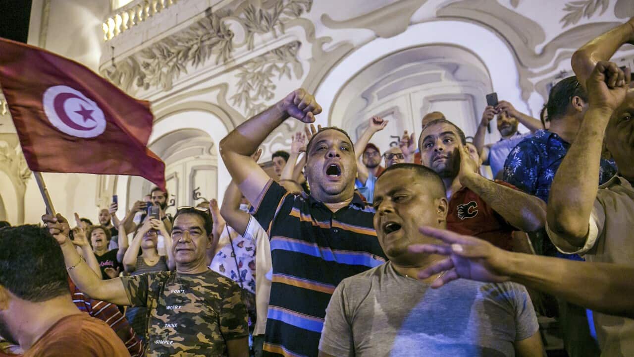 Tunisians celebrate the exit polls indicating a vote in favor of the new Constitution