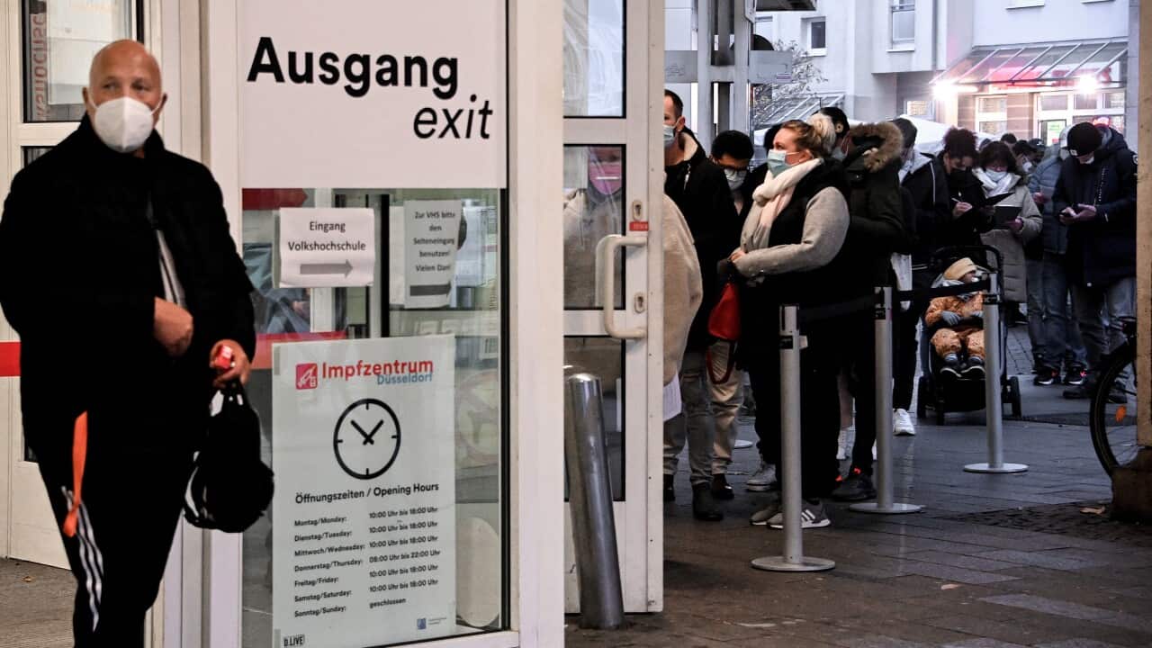 People queue for Covid-19 coronavirus vaccination at the main station vaccination center in Duesseldorf, Germany, 23 Nov 2021