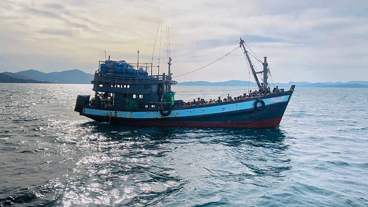 A handout photo on 5 April shows a wooden boat carrying suspected Rohingya migrants detained in Malaysian territorial waters off the island of Langkawi