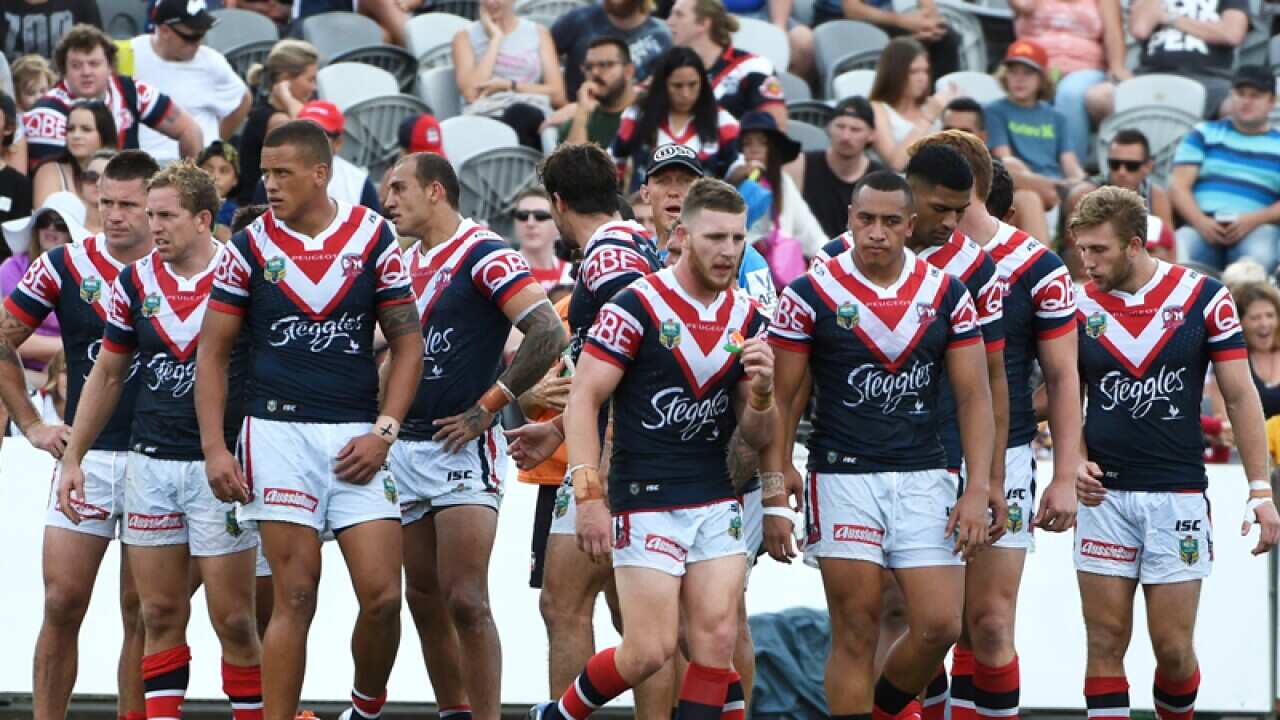 The Roosters players look on