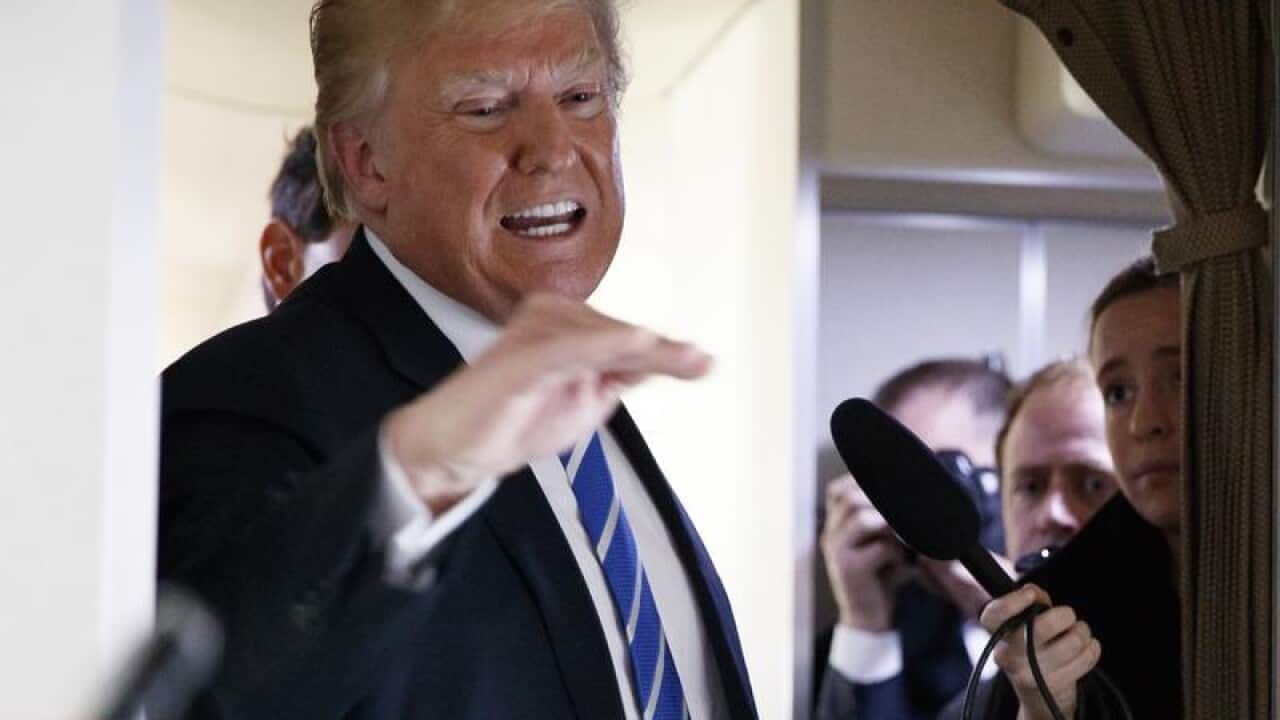 US President Donald Trump speaks to reporters on Air Force One