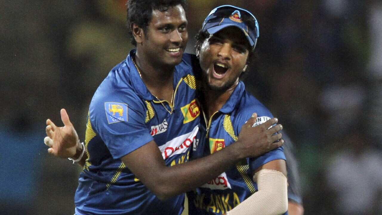 Angelo Mathews, left, and captain Dinesh Chandimal celebrate.
