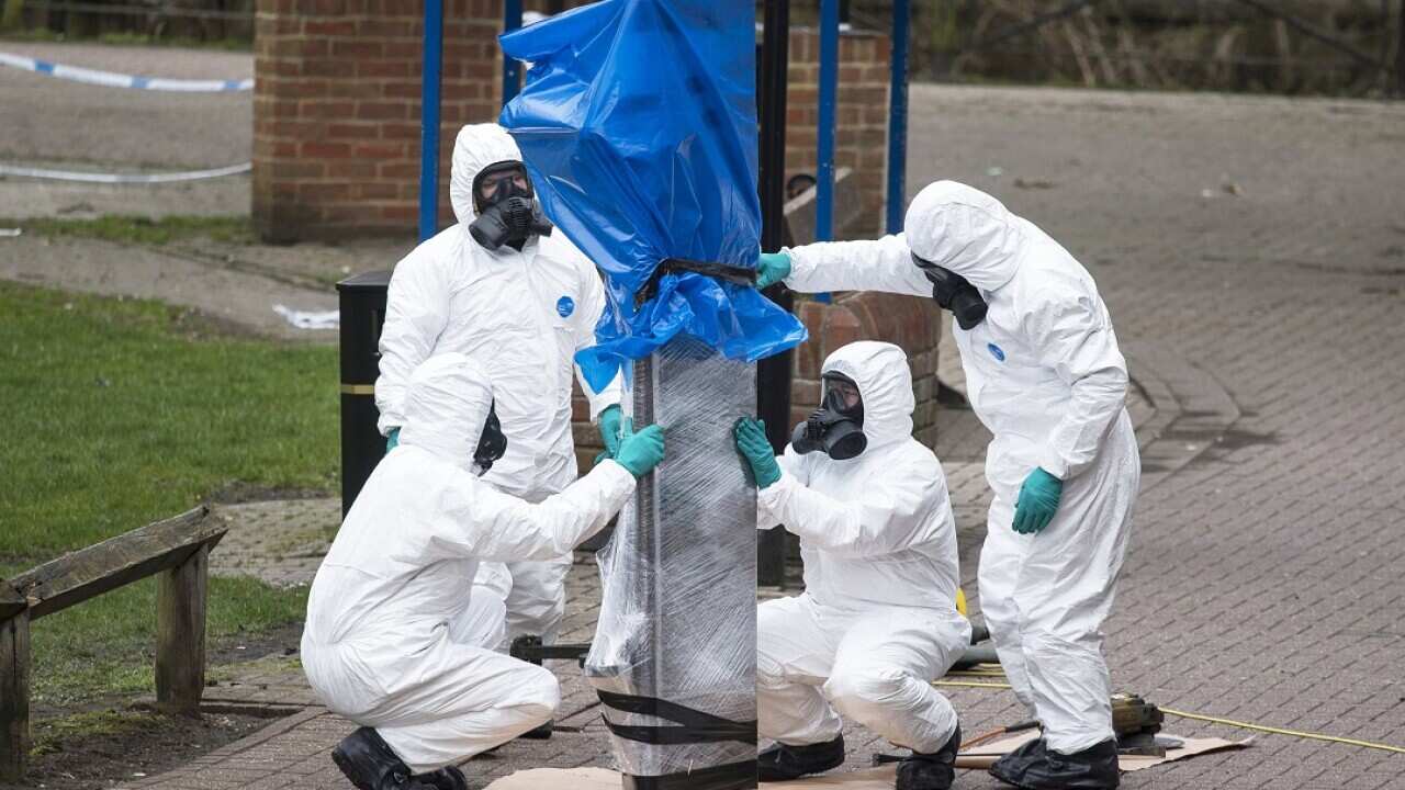Army officers remove the bench where Sergi Skripal and his daughter were found.
