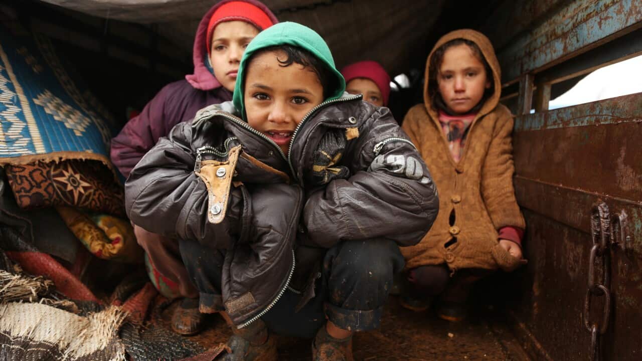 Displaced, refugee Syrian children live in a truck after fleeing violence near the Turkish border