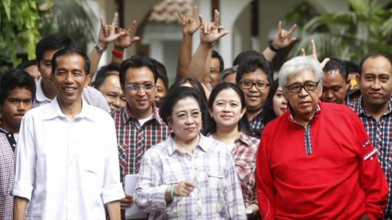 President Joko Widodo (left), pictured when running for Jakarta governor in 2012, beside foormer Megawati Sukarnoputri (centre), her husband Taufiq Kiemas, and Puan Maharani.