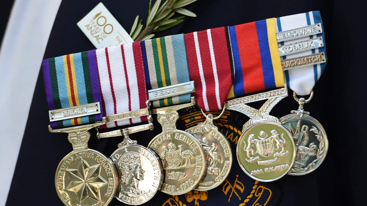 Medals are worn by an ex-serviceman during Anzac Day