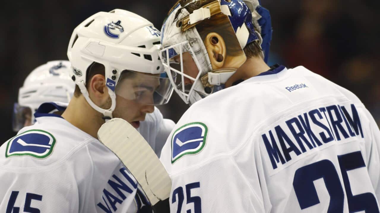 Vancouver Canucks center Michael Chaput (L) and goalie Jacob Markstrom