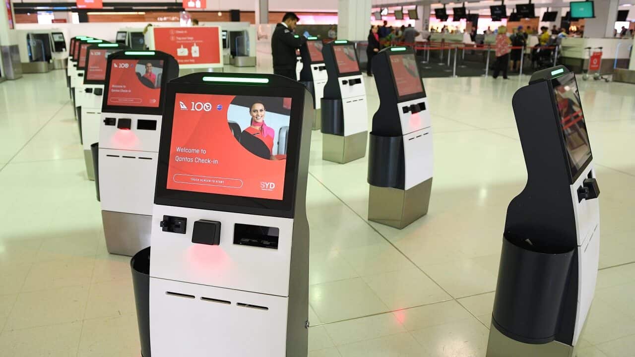 Deserted Qantas self-serve check-in kiosks at Sydney International Airport