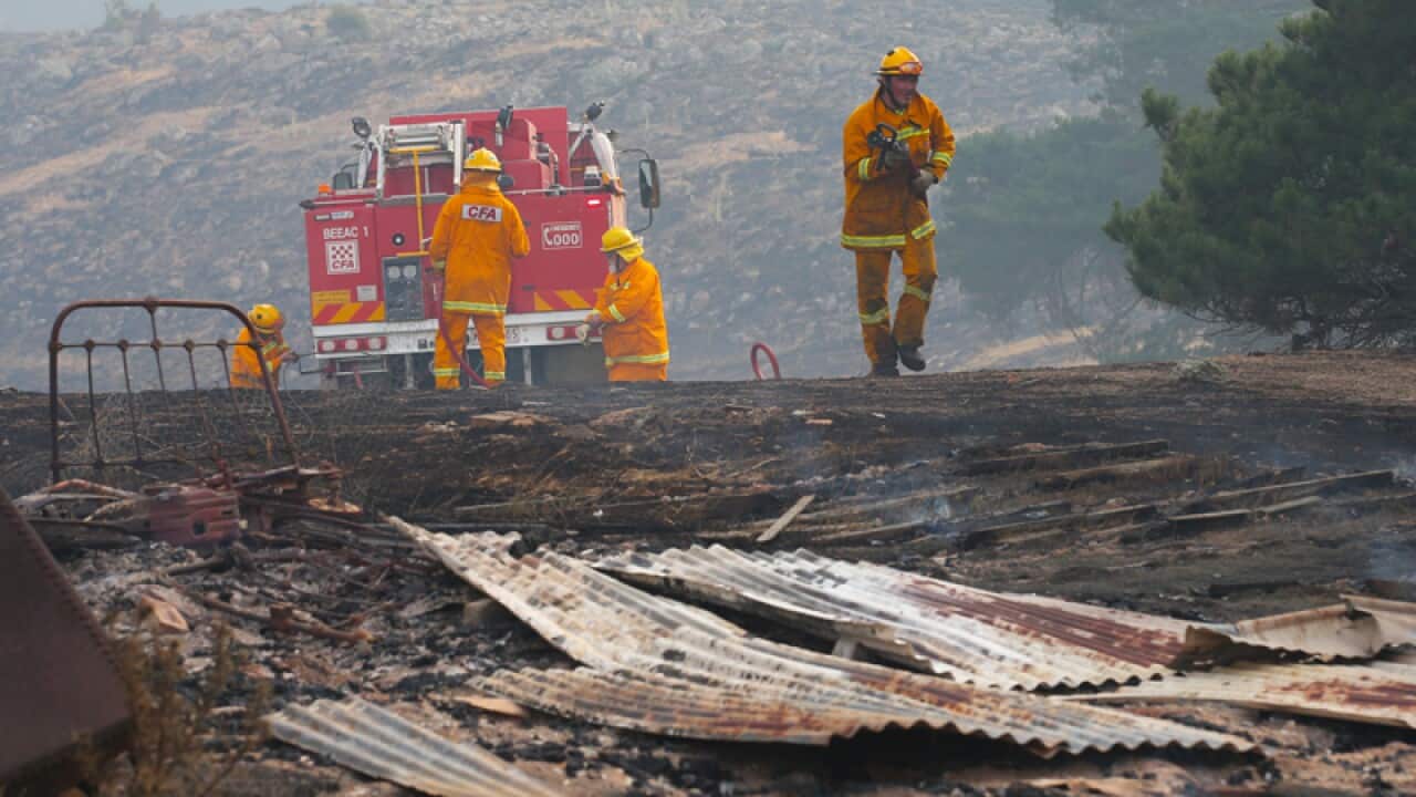 Firefighters work to contain a bushfire near Scotsburn