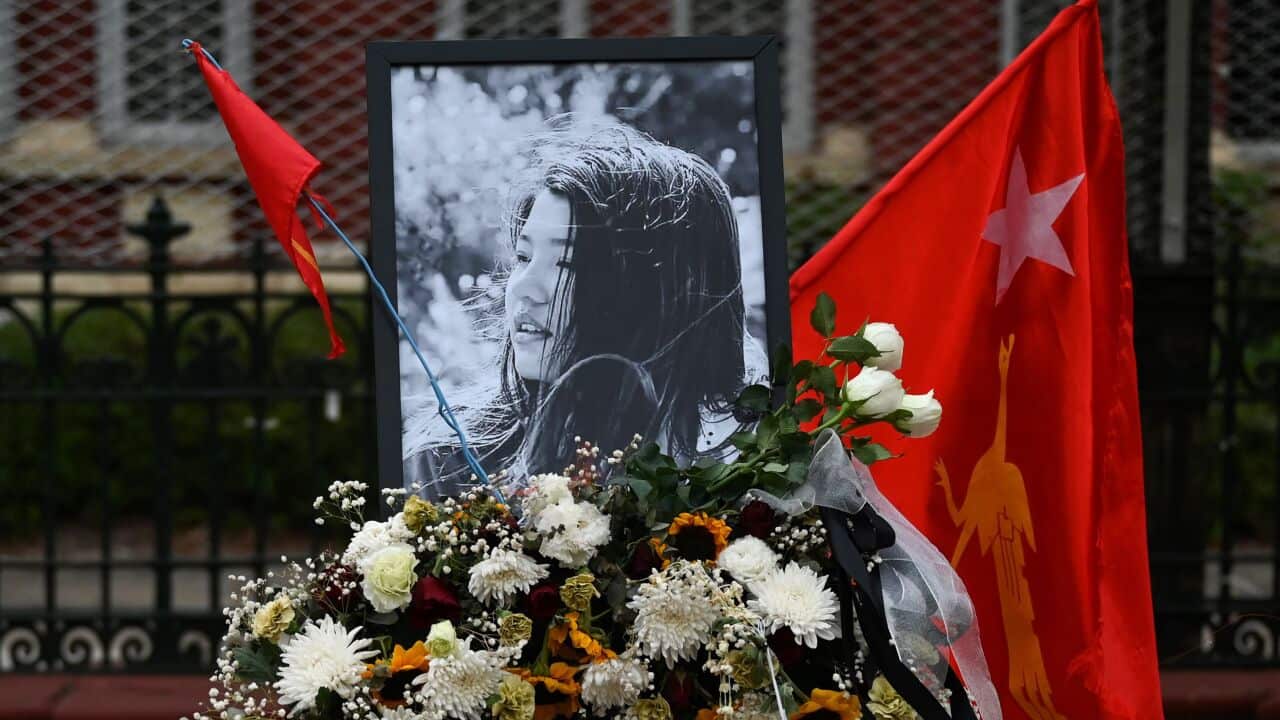 Flowers, a portrait and flag of the National League for Democracy party are displayed in honour of Mya Thwate Thwate Khaing, during a demonstration in Yangon.