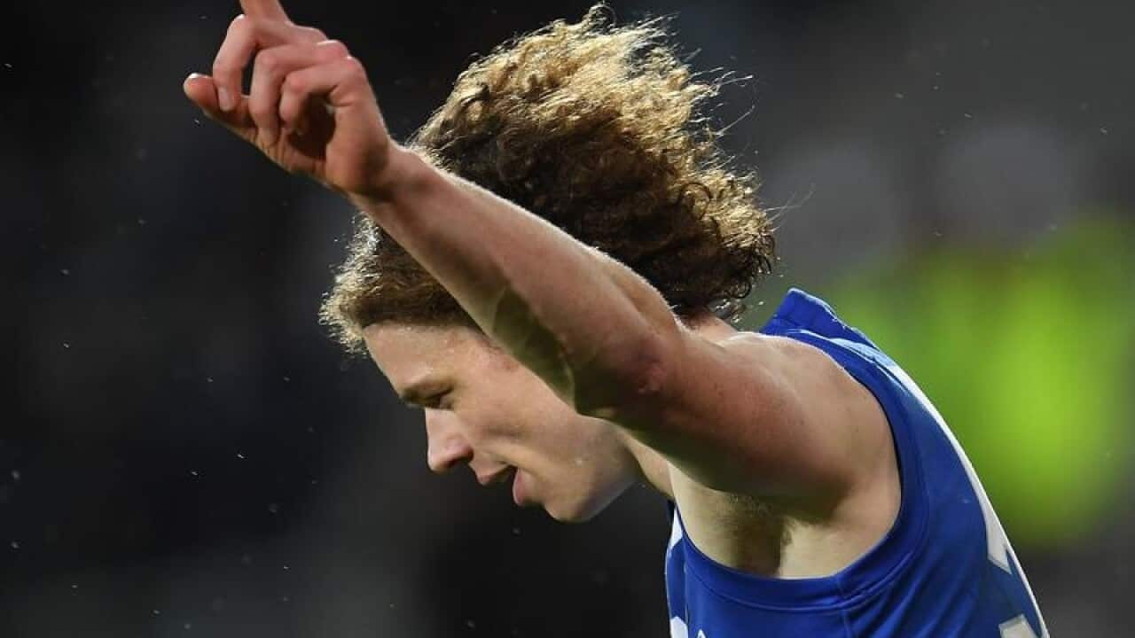 Ben Brown of the Kangaroos reacts after kicking a goal.