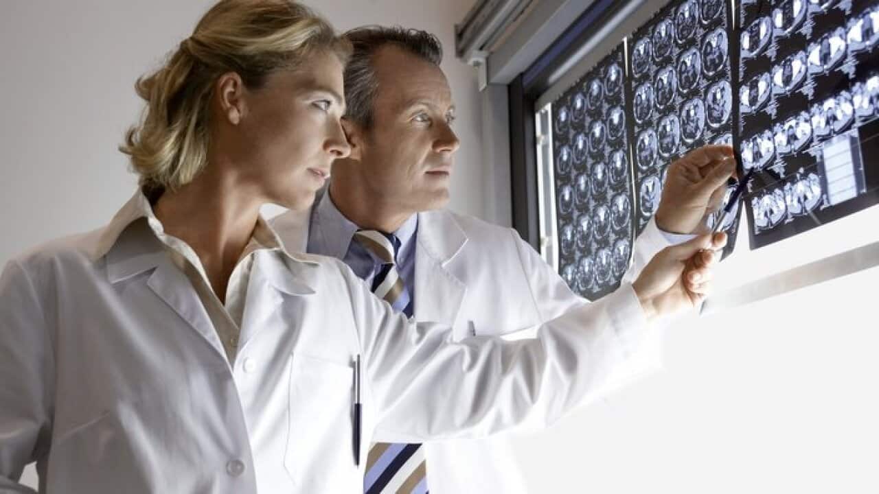 Doctors Examining brain scans in hospital side view
