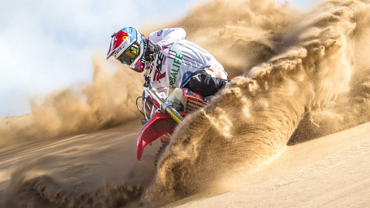 A general photo of the Dakar Rally and the effects its terrain can have on a rider.