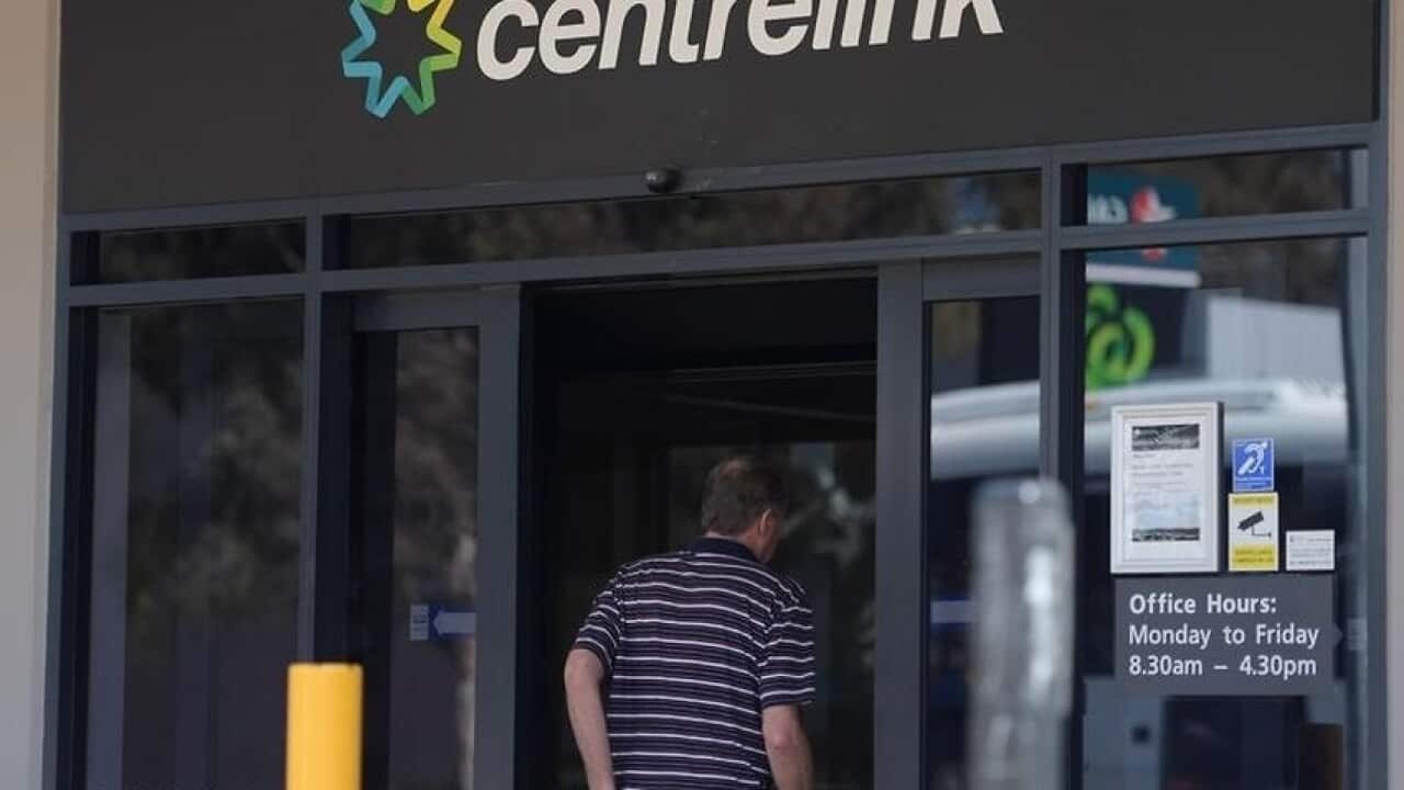 A man enters a Centrelink branch in Australia