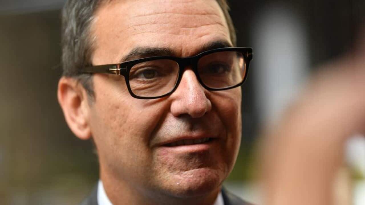 SA Liberal Leader Steven Marshall looks on.