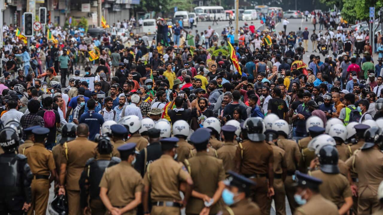 people protest as police watch
