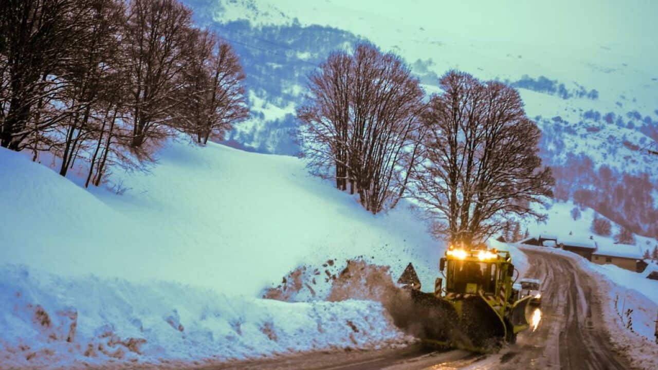 A snowplow clears a road leading to the French Alps ski resort of Les Menuires on January 4, 2018 after the region was swept by storm Eleanor.