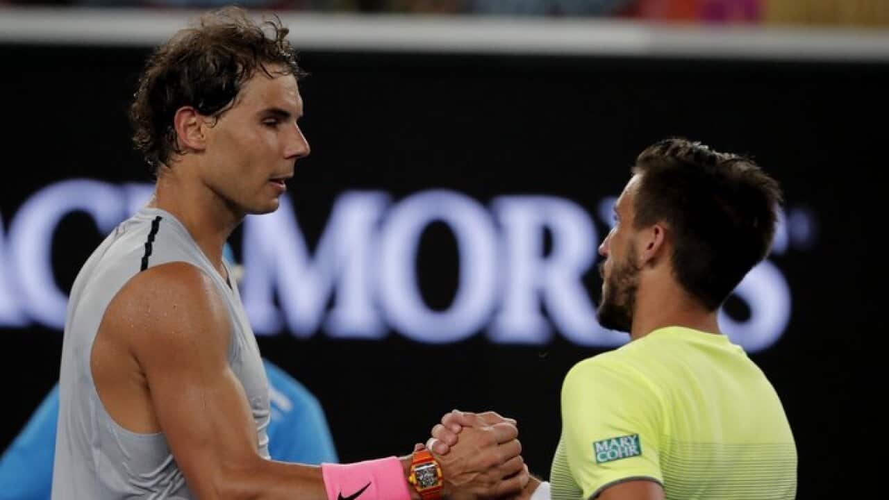 Spain's Rafael Nadal, left, shakes hands with Damir Dzumhur of Bosnia and Herzegovina after winning their third round match at the Australian Open tennis championships in Melbourne, Australia, Friday, Jan. 19, 2018. (AP Photo/Vincent Thian)