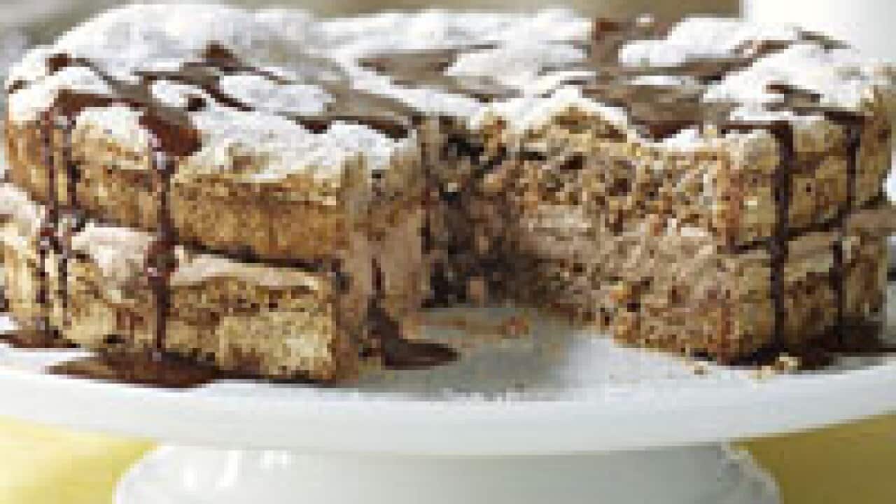 Hazelnut meringue cake with chocolate sauce