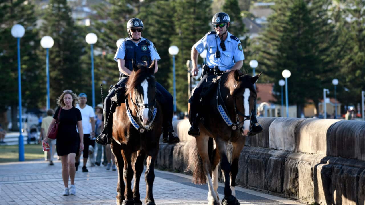 Mounted police patrol a closed Coogee Beach in Sydney.