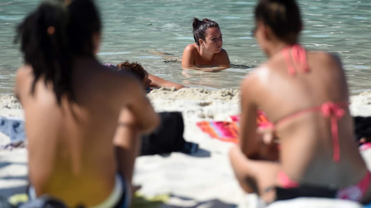 People escape the hot weather at South Bank beach in Brisbane