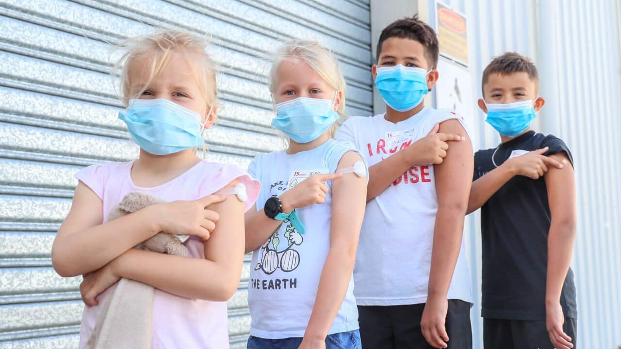 Children pose for a photo after receiving their first vaccine at Kippa Ring Communication Vaccination Clinic on Brisbane on 10 January 2022.