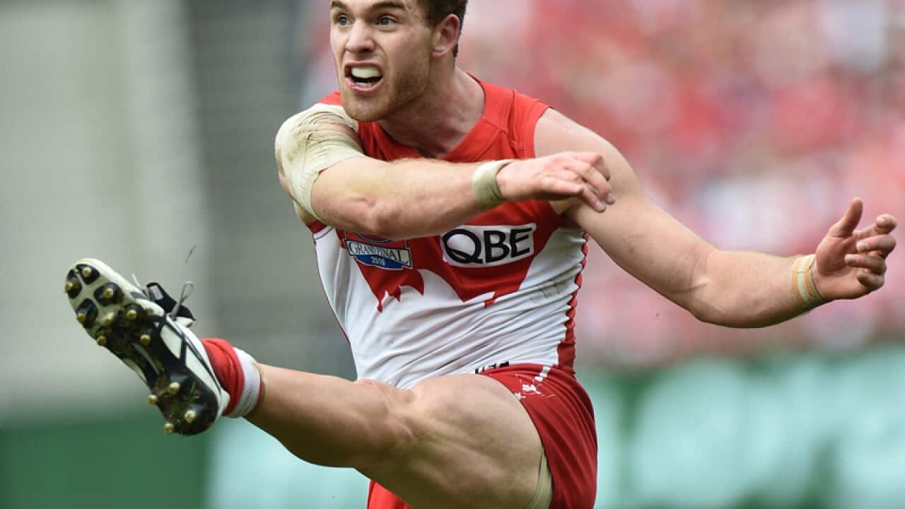 Tom Mitchell of the Swans kicks a goal