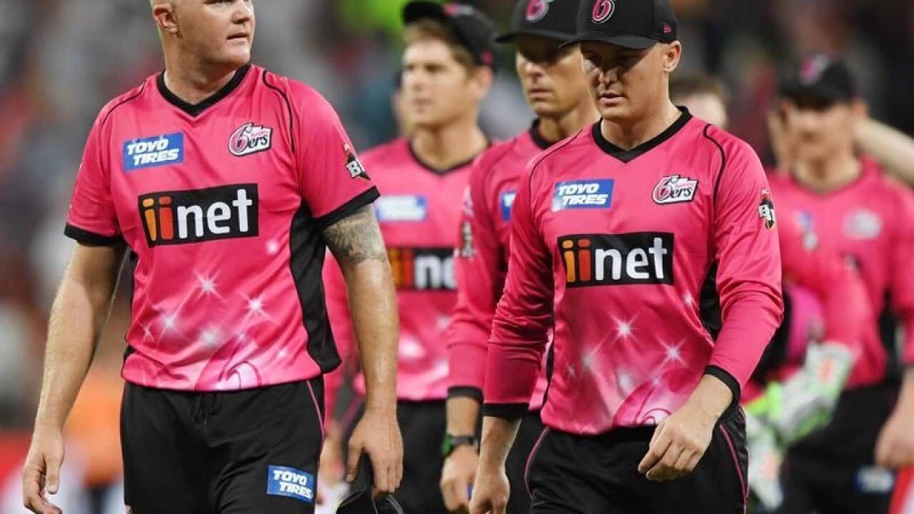 Sydney Sixers players leave the pitch after losing