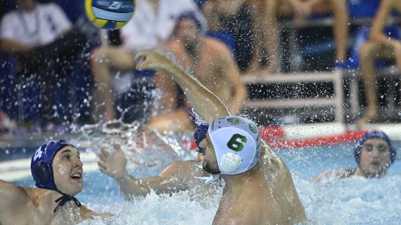 Ubovic (C) in action against Jokovic (L) during the men's LEN Champions League quarter final water polo match in Belgrade, Serbia, 02 June 2022.
