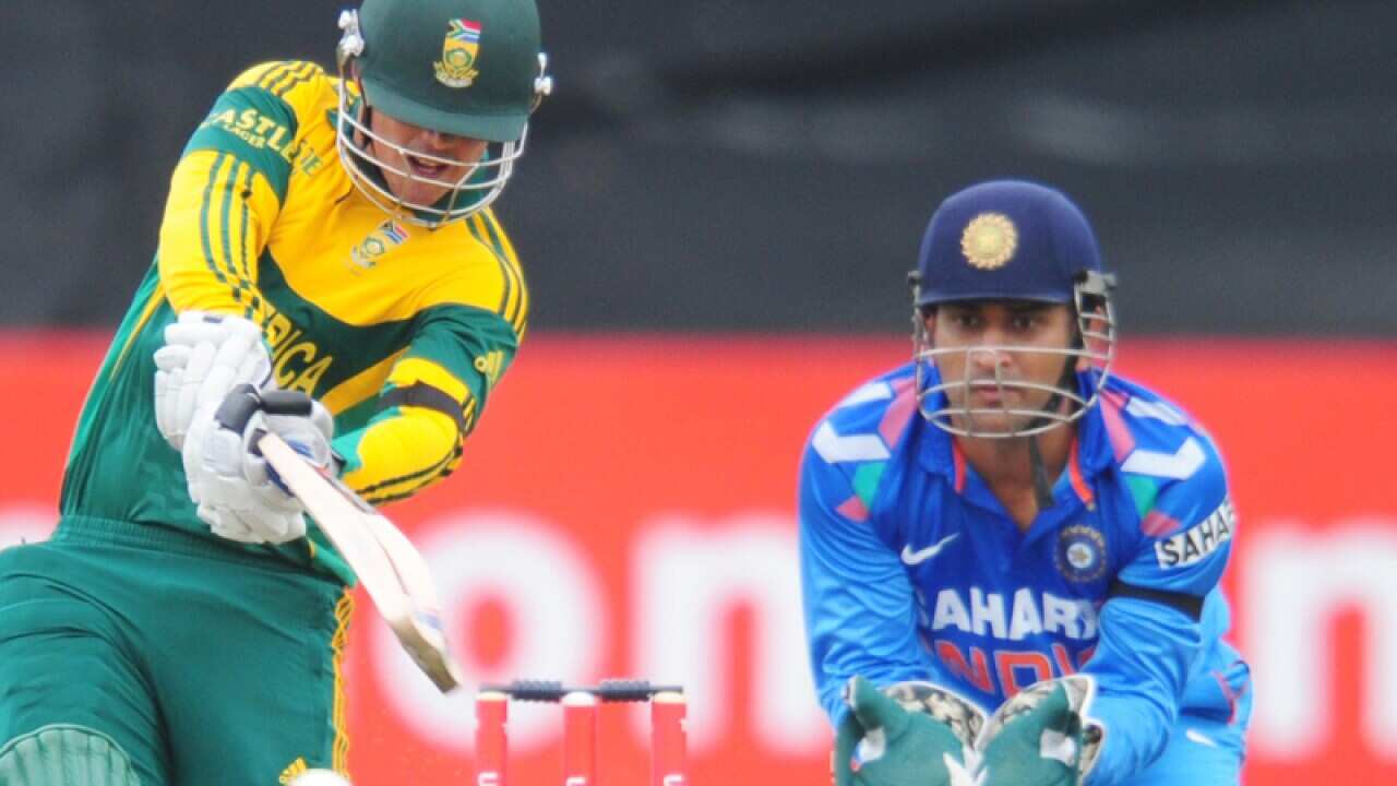 South Africa's Quinton de Kock, left, drives the ball.