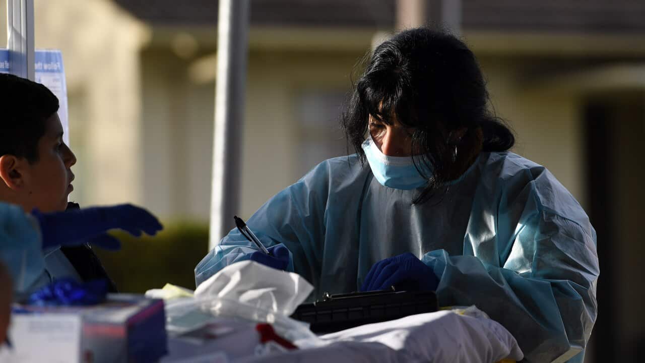 Healthcare workers are seen at a coronavirus pop-up testing facility in Broadmeadows, Melbourne, Friday, June 26, 2020.