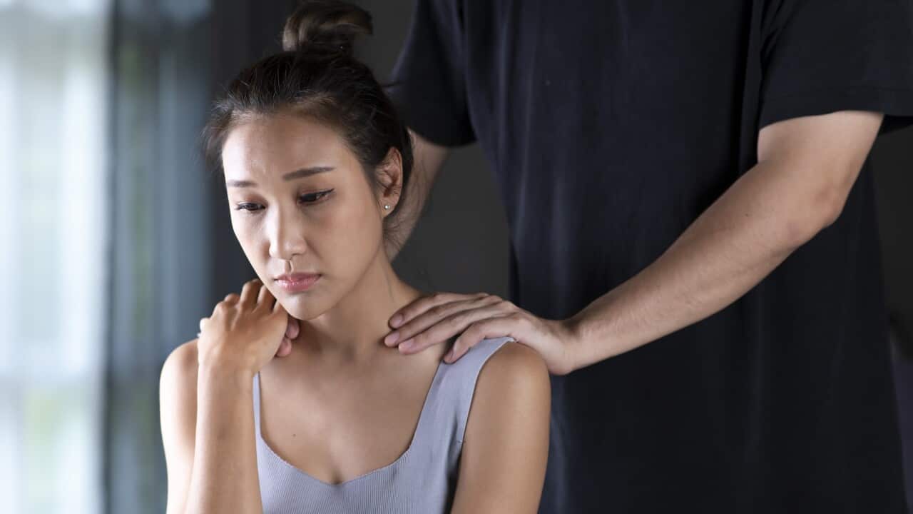 Husband trying to comfort his wife at home.