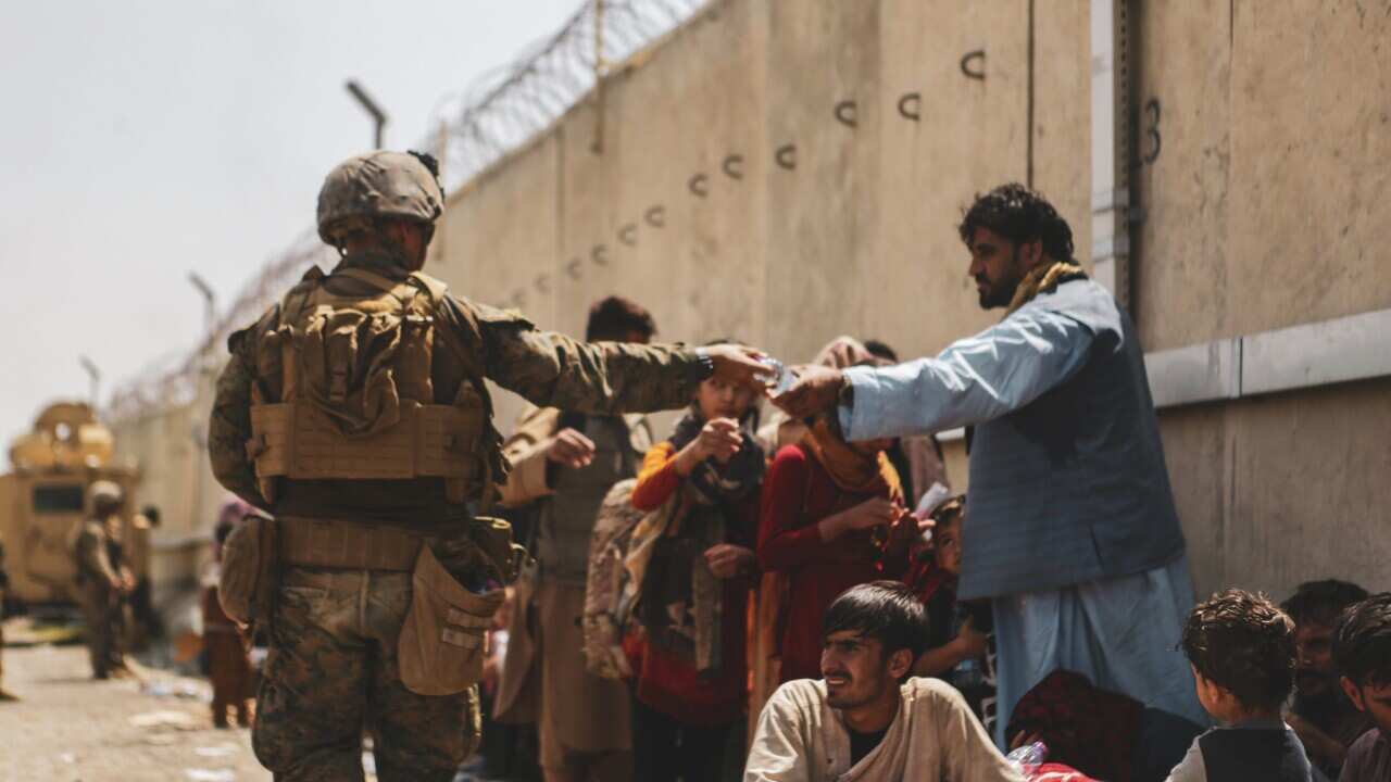 A Marine with the 24th Marine Expeditionary unit (MEU via Sipa USA) passes out water